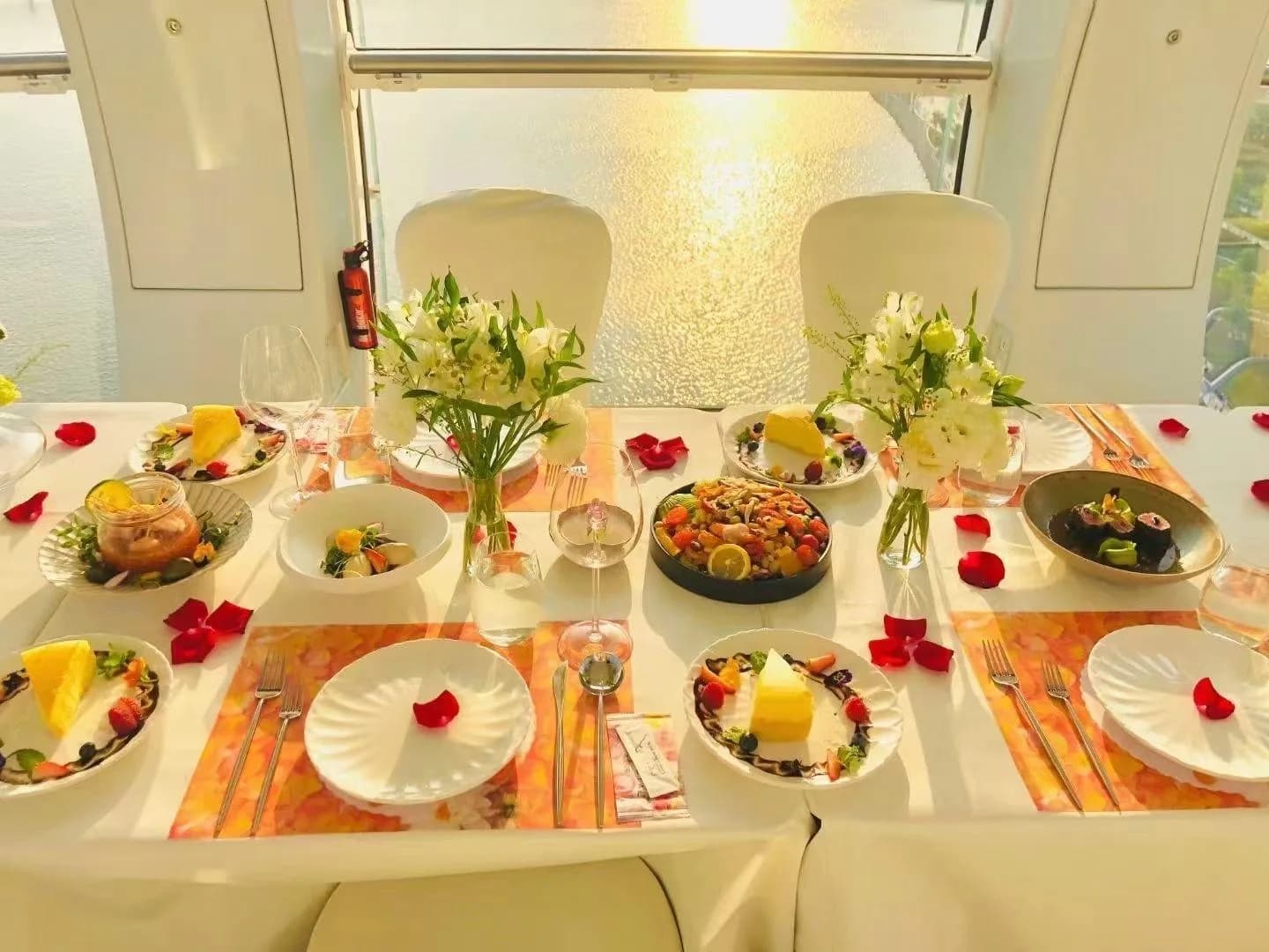 A table prepared for a dining experience inside a wheel cabin, as shown in Juma's profile